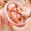 Baby doll in carrier with mascot pink