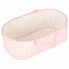 Baby doll in carrier with mascot pink